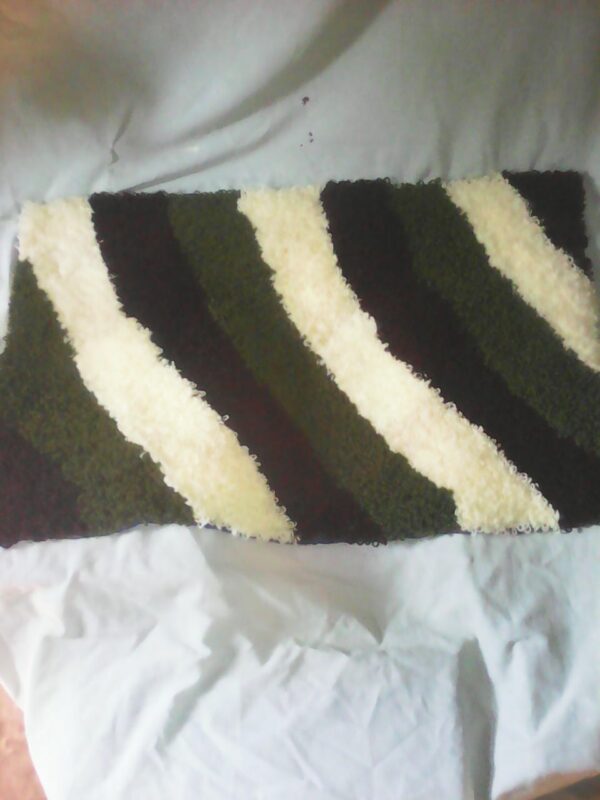 a hand woven classic rug, to use as bathroom or door mat .